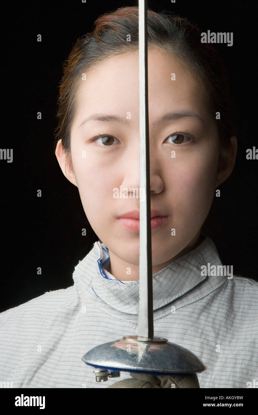 Portrait of a female fencer holding a fencing foil Stock Photo Alamy