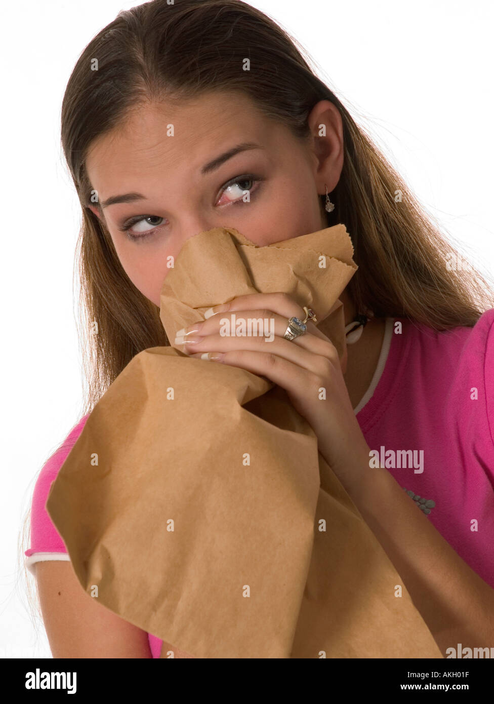 Hyperventilating Caucasian Teen Girl Breathes into Paper Bag USA Stock