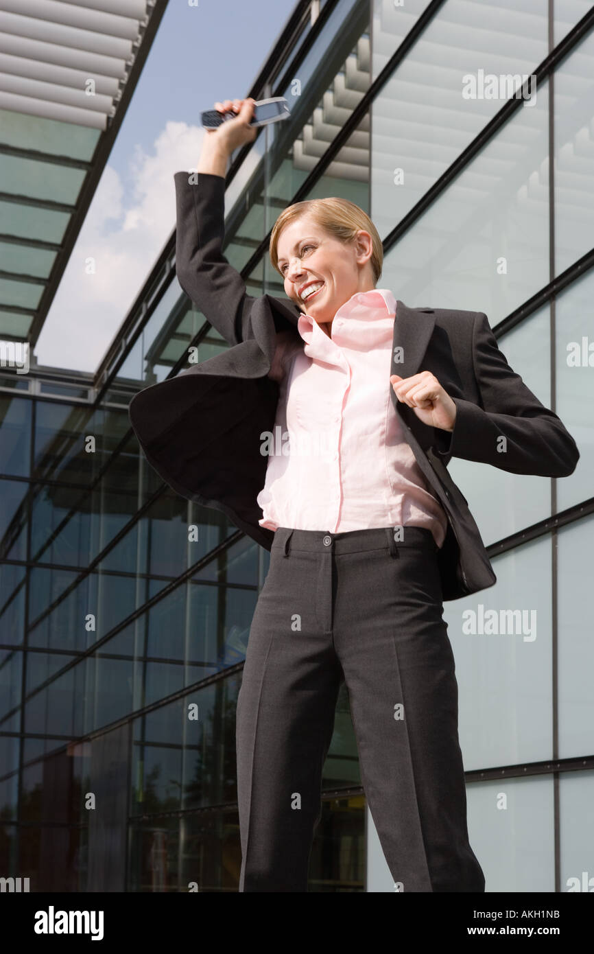 Businesswoman jumping outdoors Stock Photo
