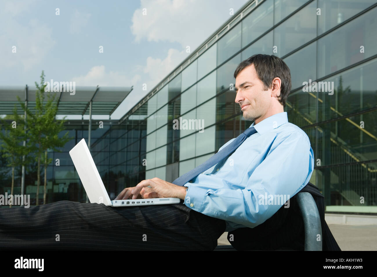 Businessman with laptop on office court Stock Photo