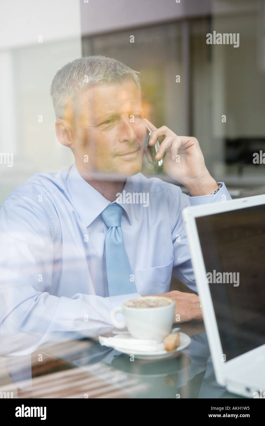 Man on phone in coffee bar Stock Photo