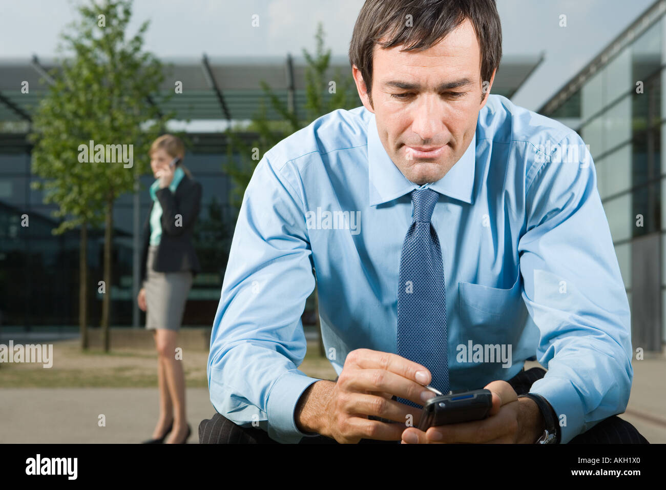 Man using handheld computer outdoors Stock Photo