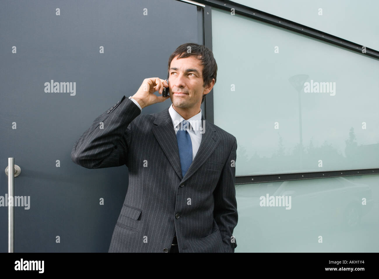 Businessman talking on mobile phone outdoors Stock Photo