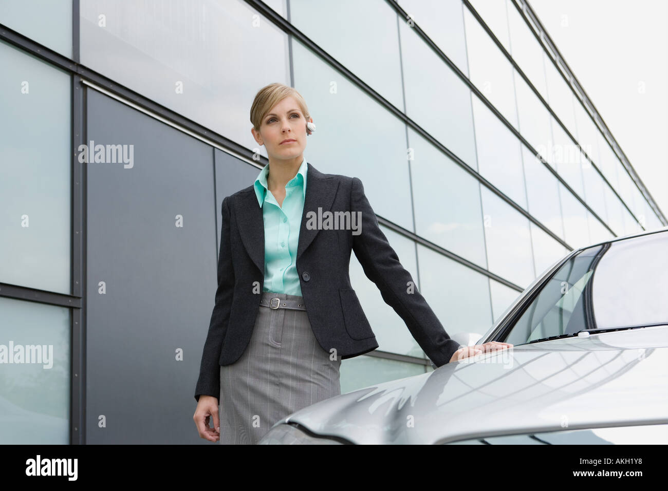 Businesswoman standing by car Stock Photo