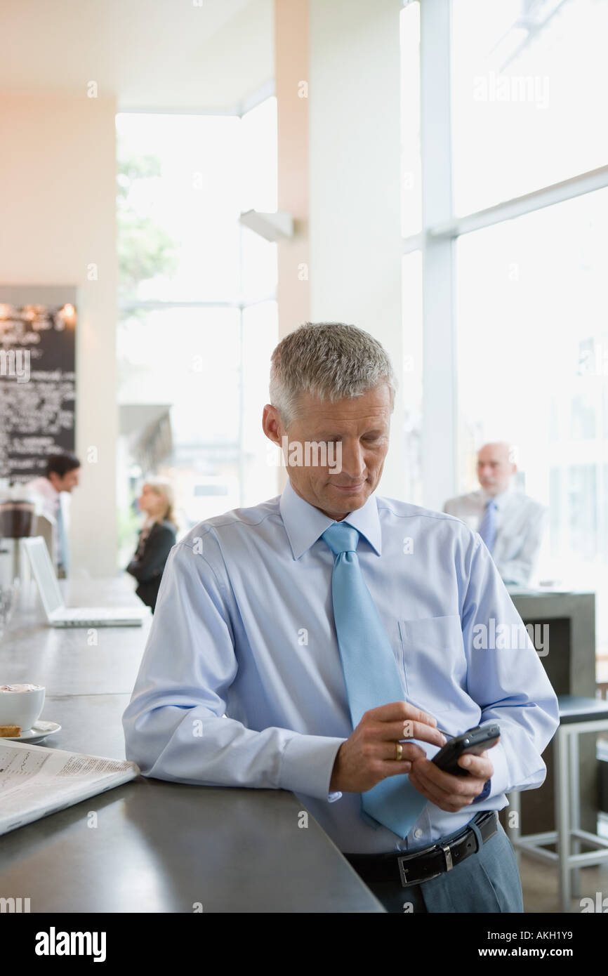 Man using handheld computer at bar counter Stock Photo