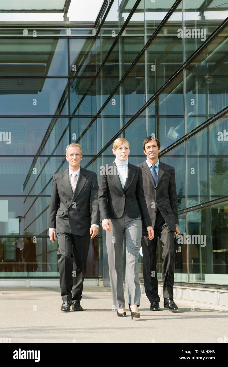 Business people walking along office building Stock Photo
