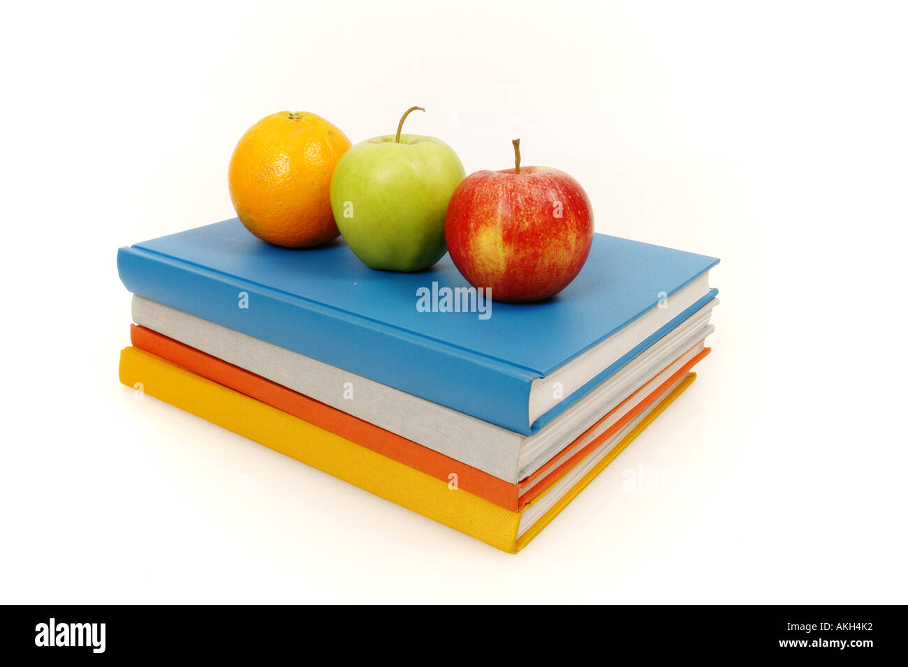 books and apple on an isolated white background Stock Photo - Alamy