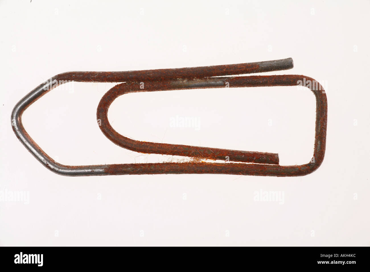 a rusty old paperclip on white Stock Photo - Alamy