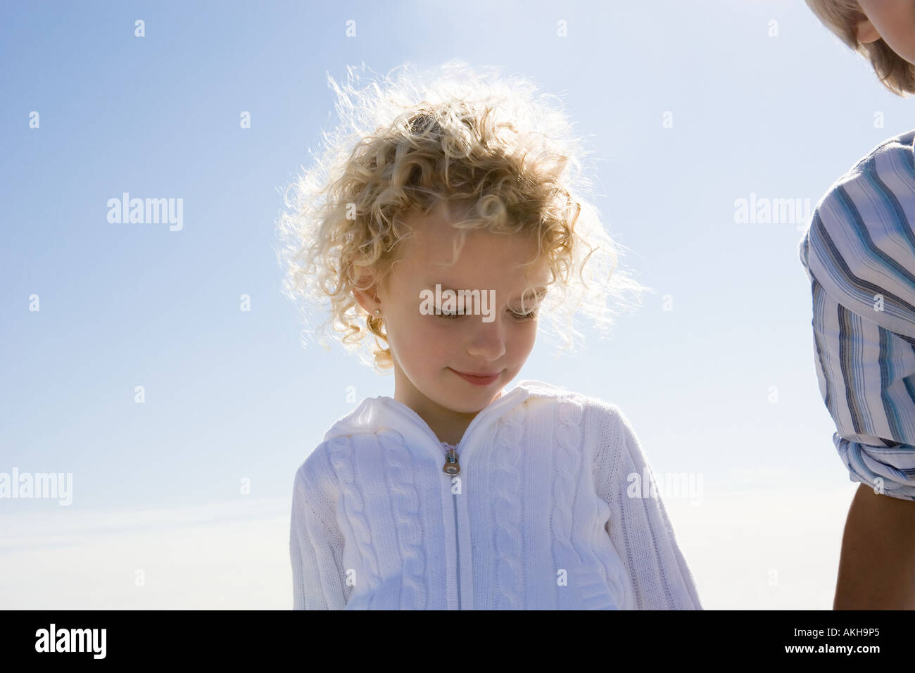 Girl and boy against blue sky Stock Photo - Alamy