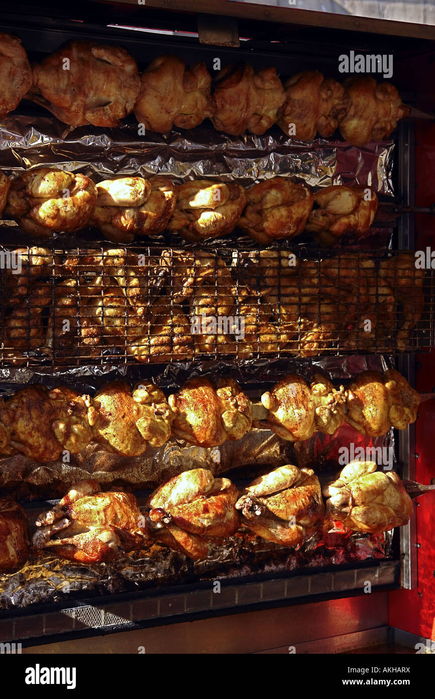 roasted chicken on revolving skewers in an open market in Paris France Stock Photo Alamy