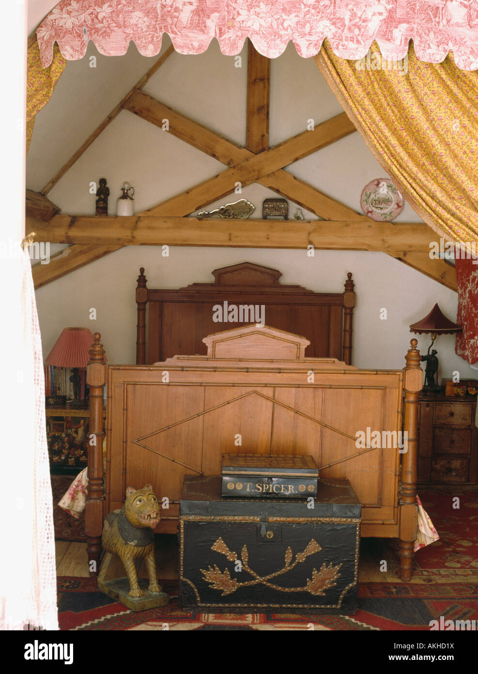 Decorated Antique Boxes In Attic Country Bedroom With Pine Bed Stock Photo Alamy