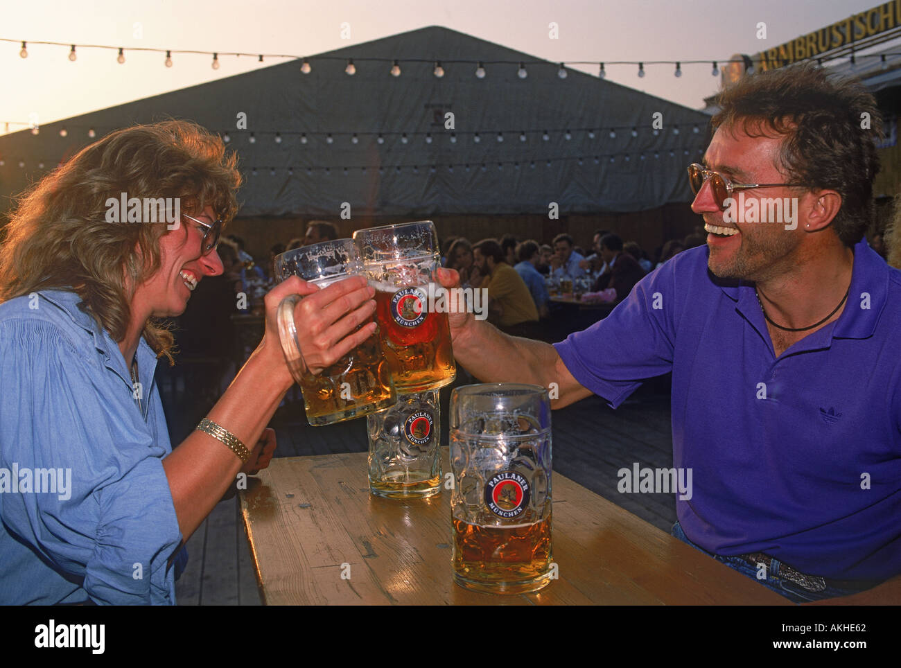 Couple having steins of beer at Oktoberfest in Munich Germany Stock Photo