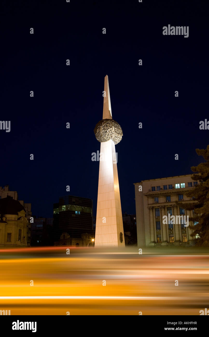 Traffic at night passes Monument Revolution square Bucharest Romania ...