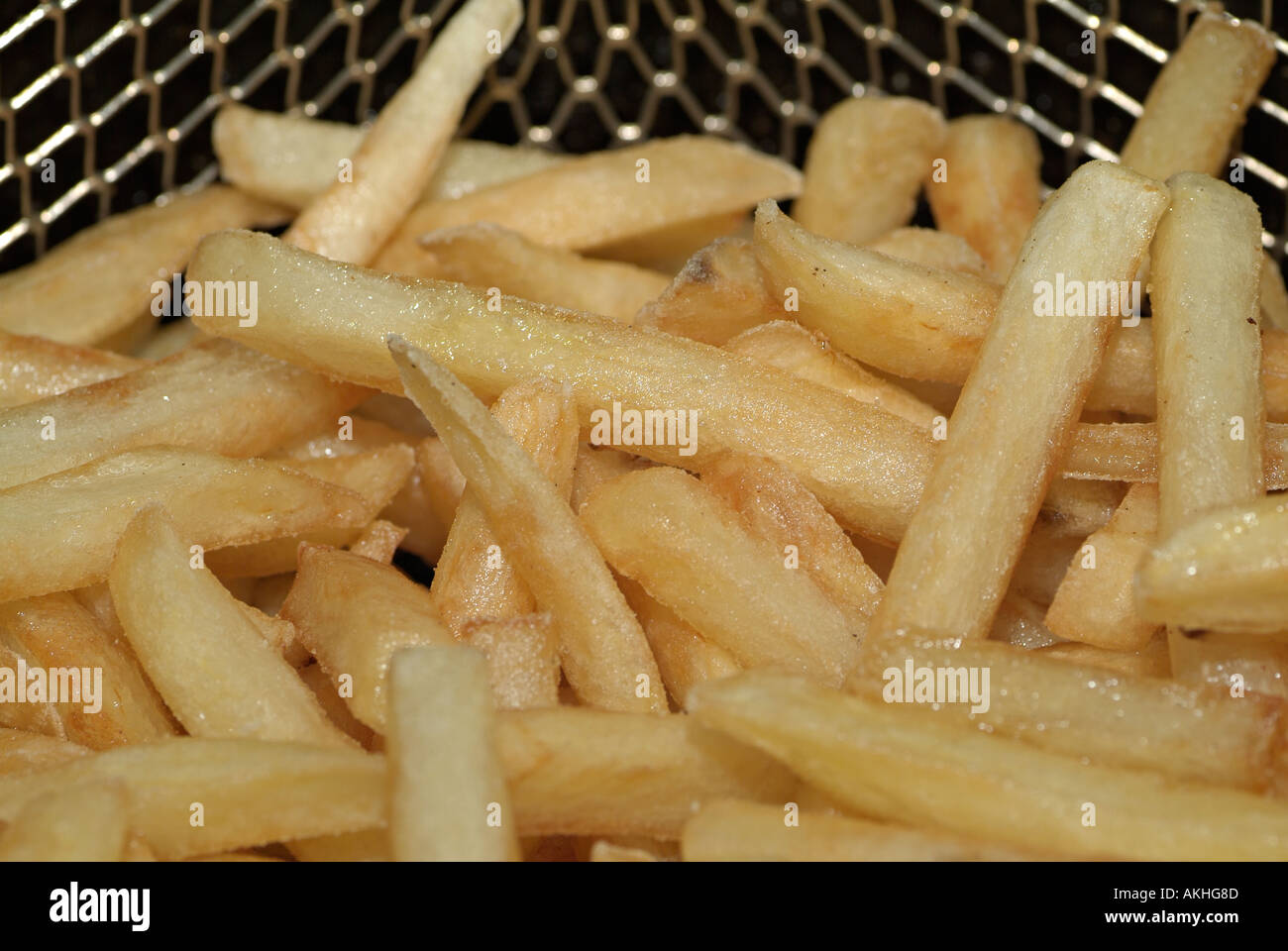 Freshly Cooked Chips in the Basket of a Deep Fat Fryer Stock Photo Alamy