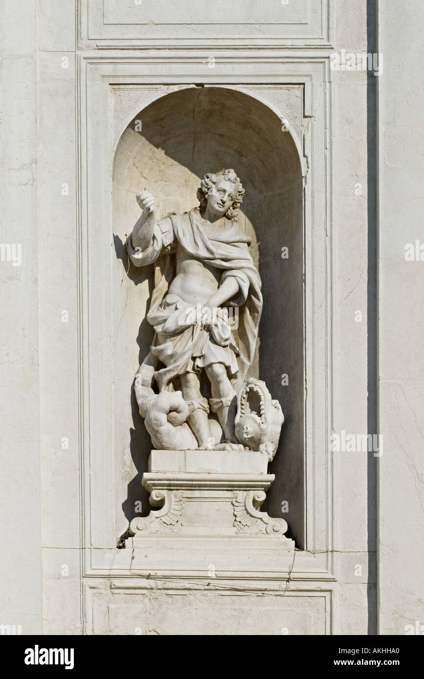 Stone Carving in a niche depicting a young man and a mythical beast or reptile with big teeth Venice 2005 Stock Photo