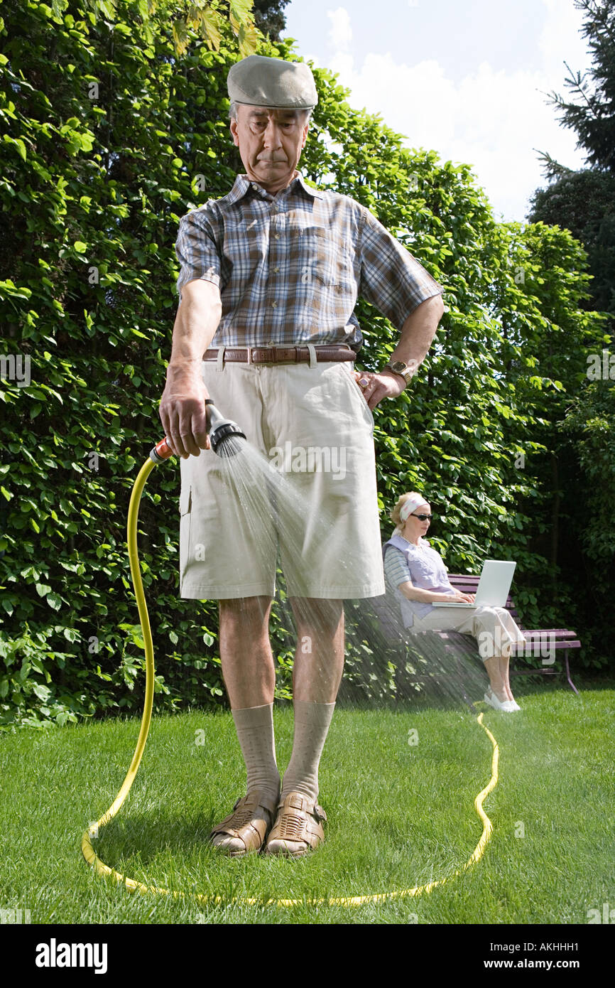 Man watering lawn Stock Photo