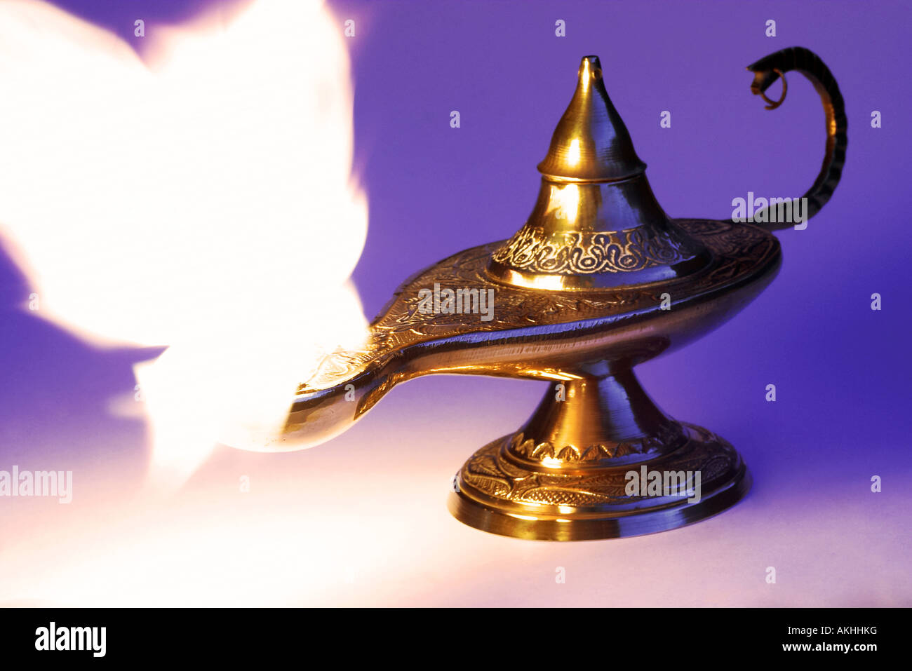 A traditional Middle Eastern Aladdin s lamp oil lamp with a huge genie flash space for text emerging from the spout Stock Photo