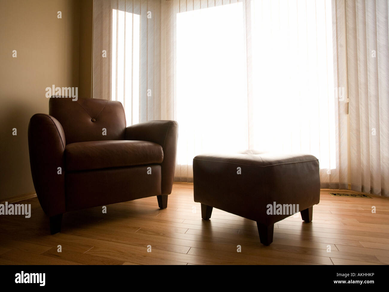 Living room with armchair and ottoman Stock Photo