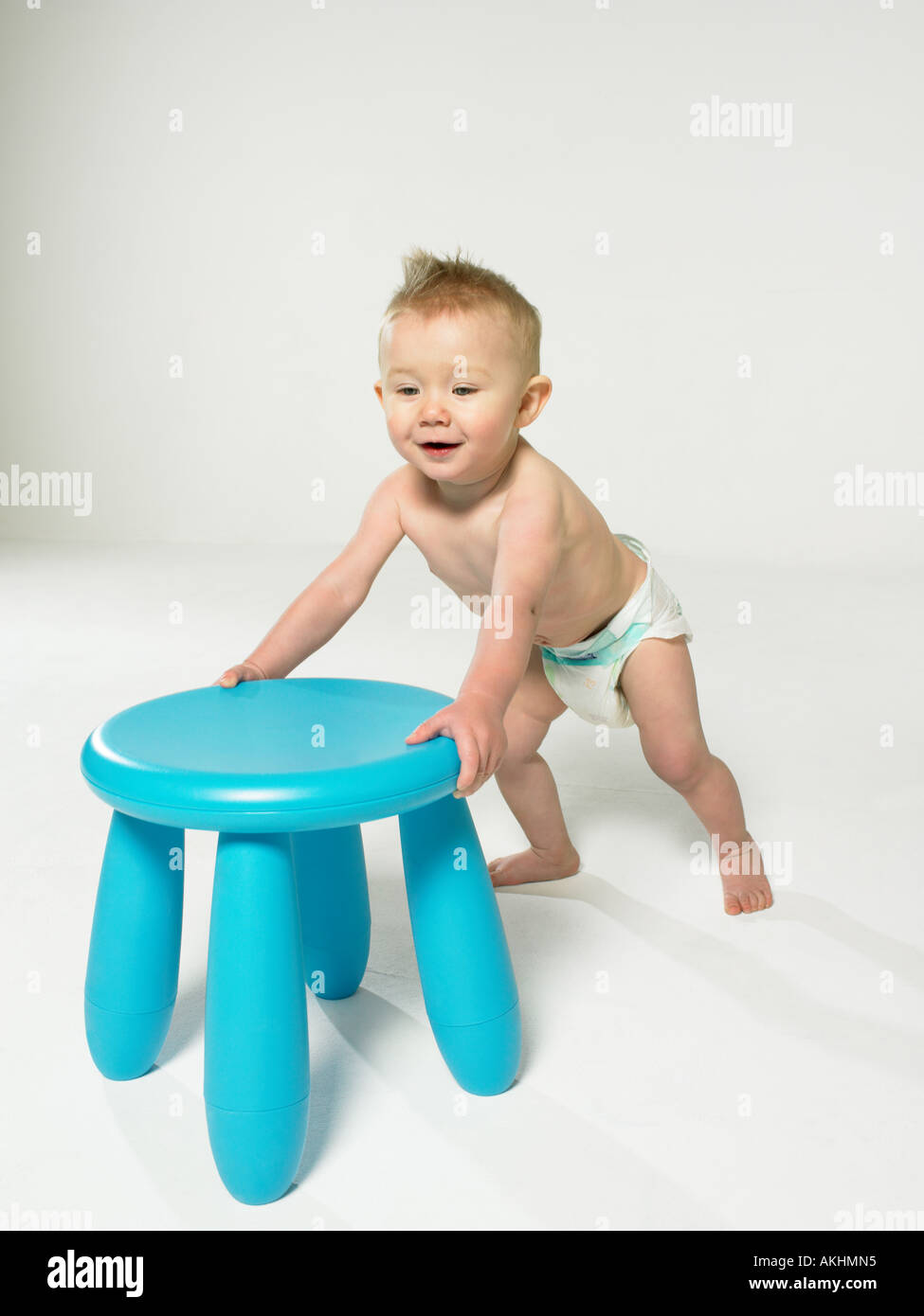 Baby with blue stool Stock Photo Alamy