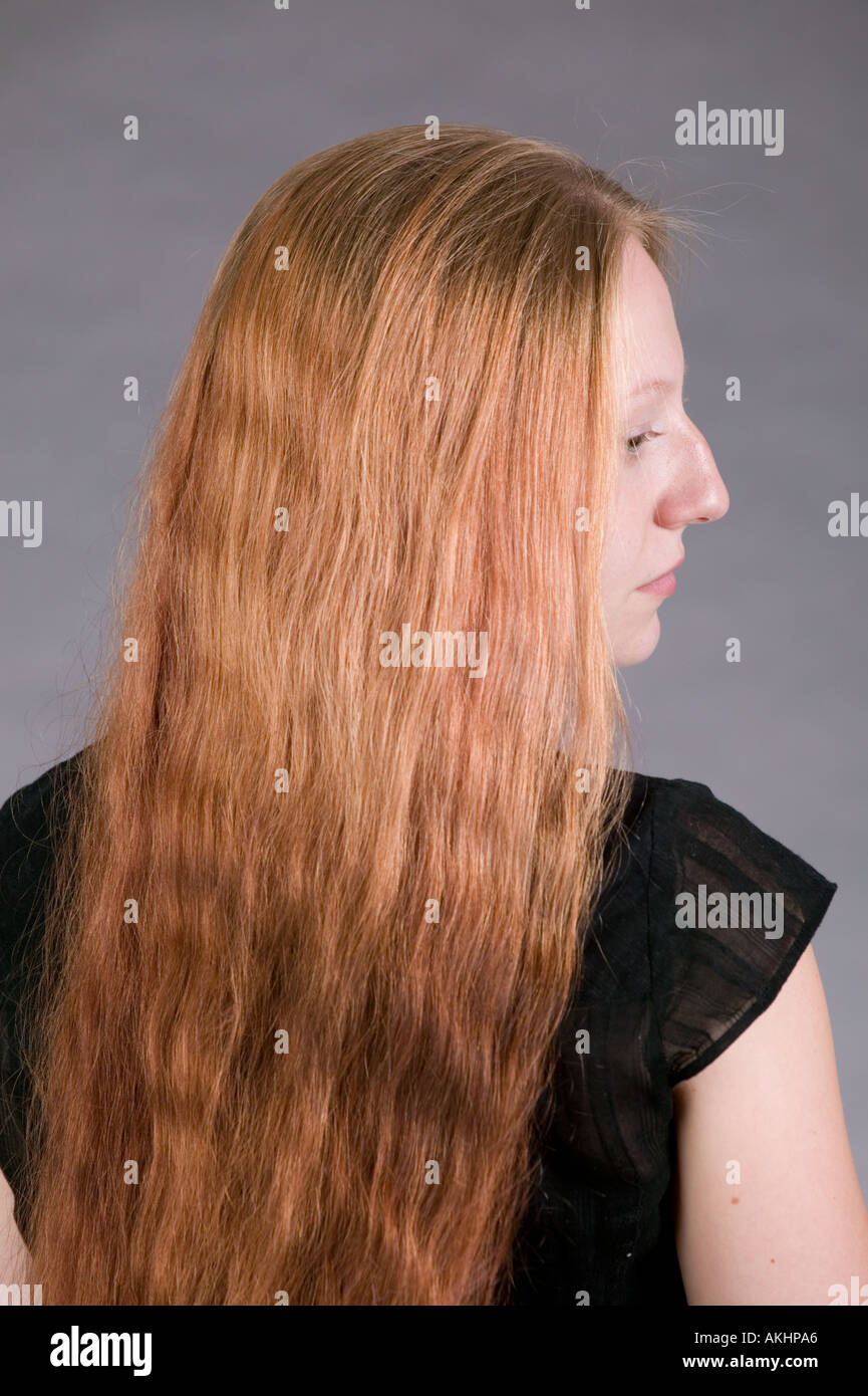 Young woman with very long red hair profile Stock Photo