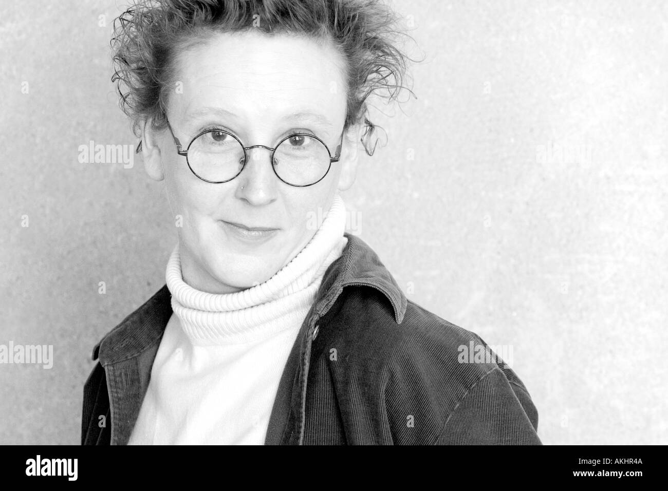 High key black and white headshot of a funky artistic Caucasian woman