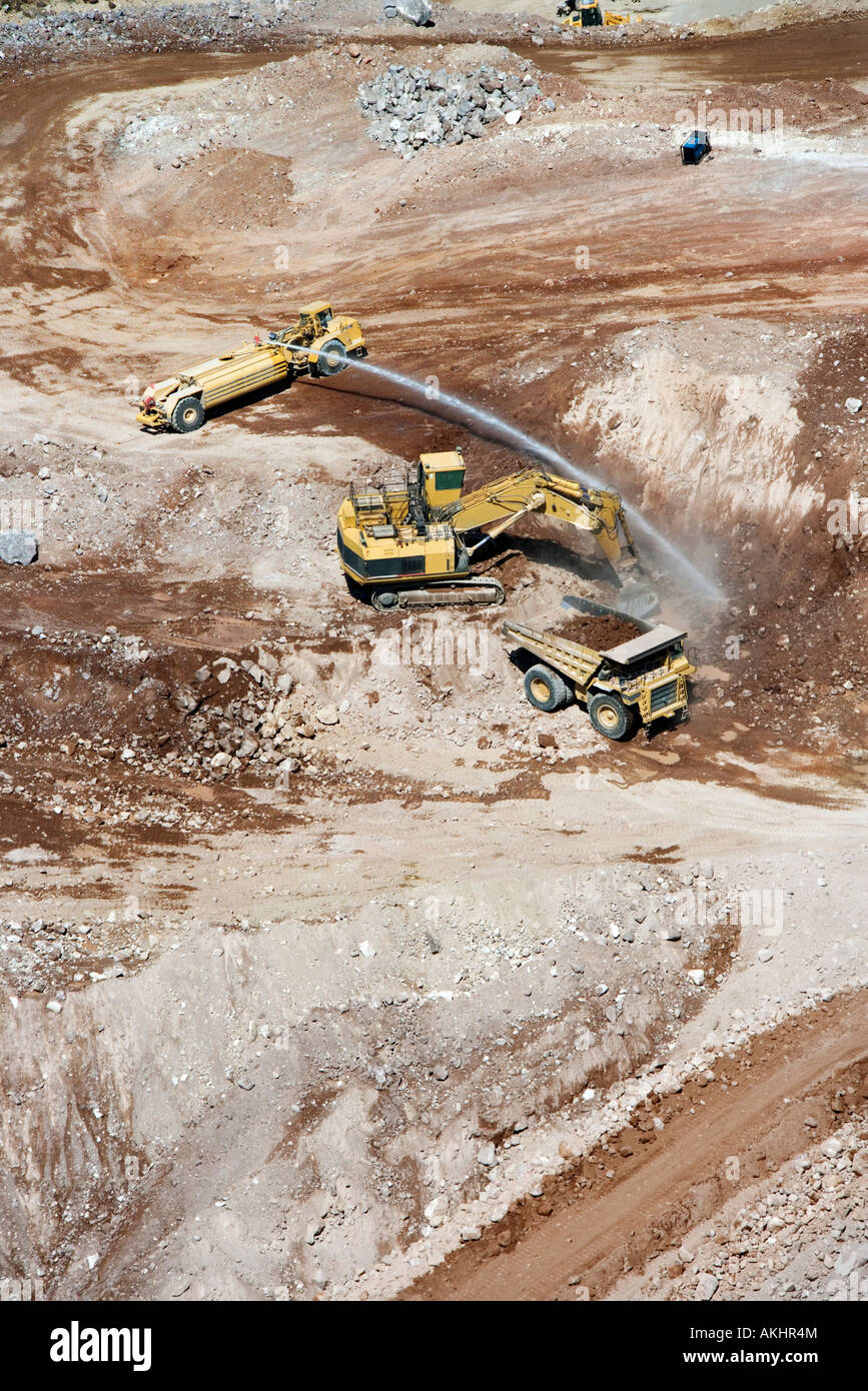 Aerial of heavy equipment vehicles in suburban land development area of