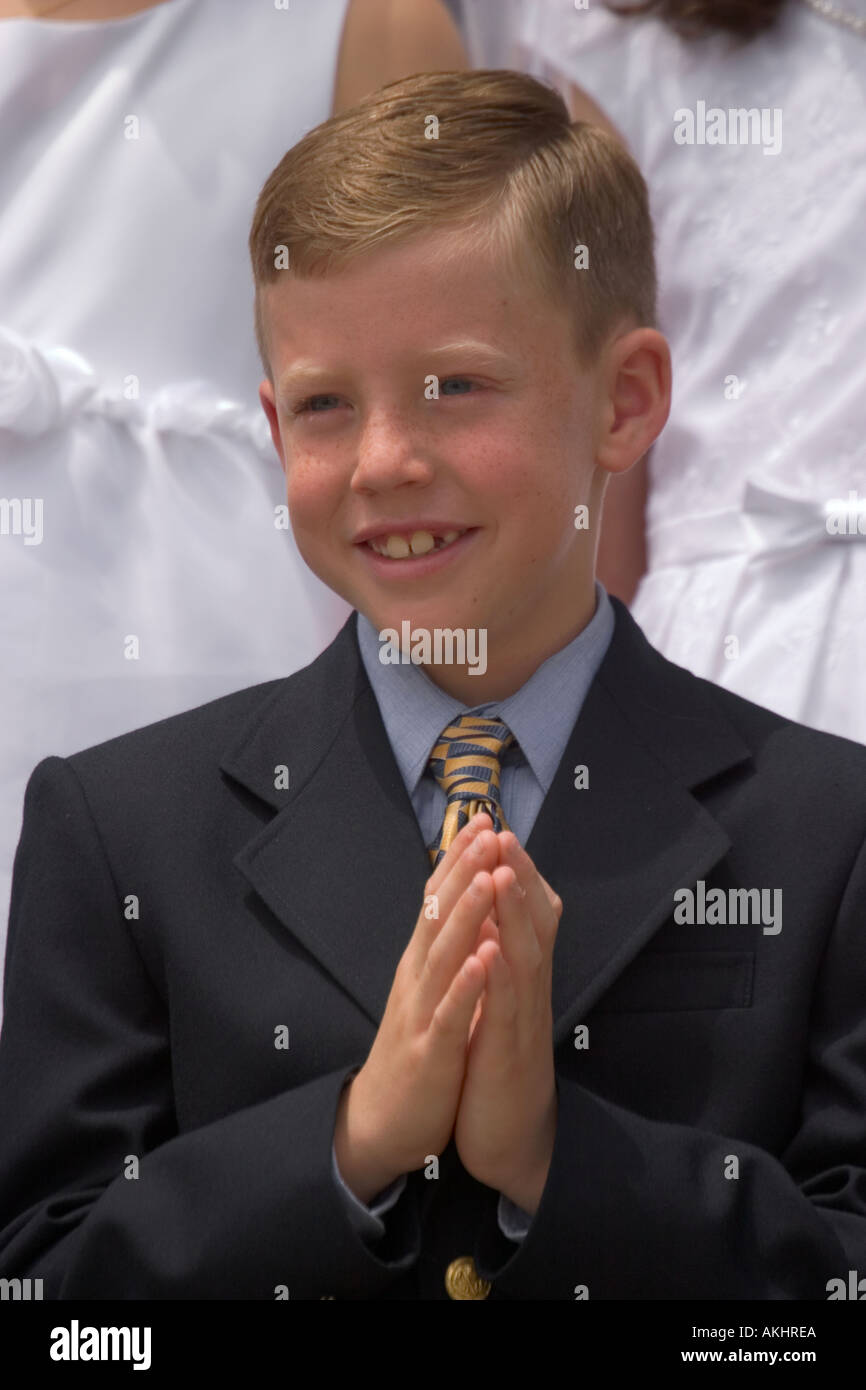 A smiling boy on the day of his First Communion Stock Photo