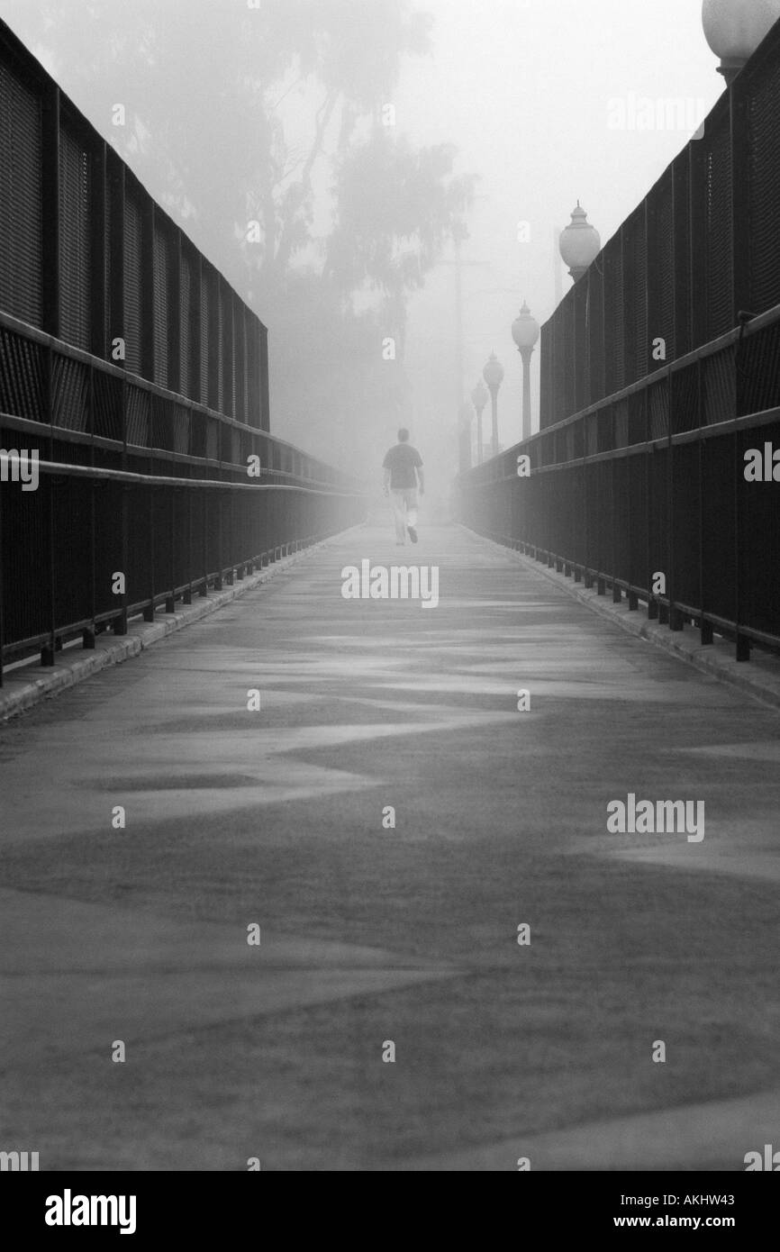 Lone figure walking Black and White Stock Photos & Images - Alamy