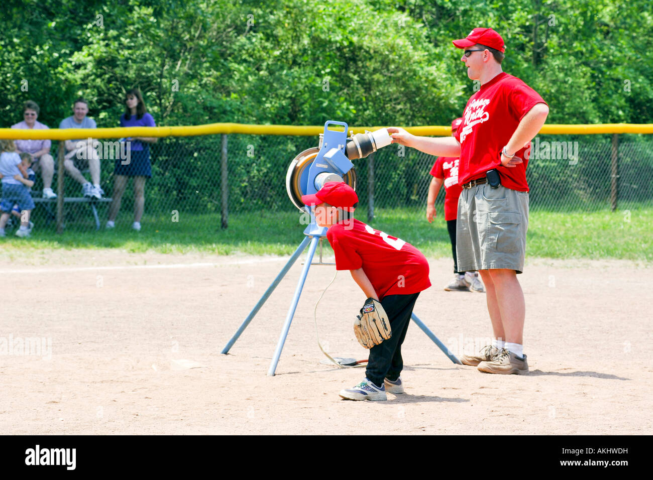A Softball pitching machine being used at a practise session Stock