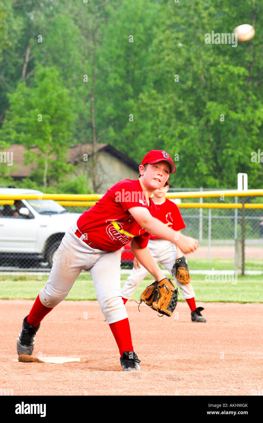 Young boy playing softball for the school team Stock Photo Alamy