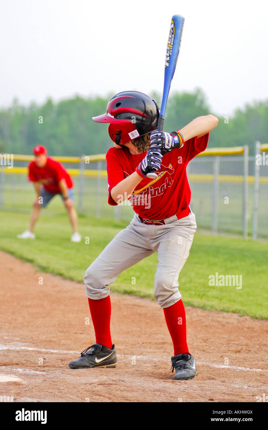 Young boy playing softball for the school team Stock Photo Alamy