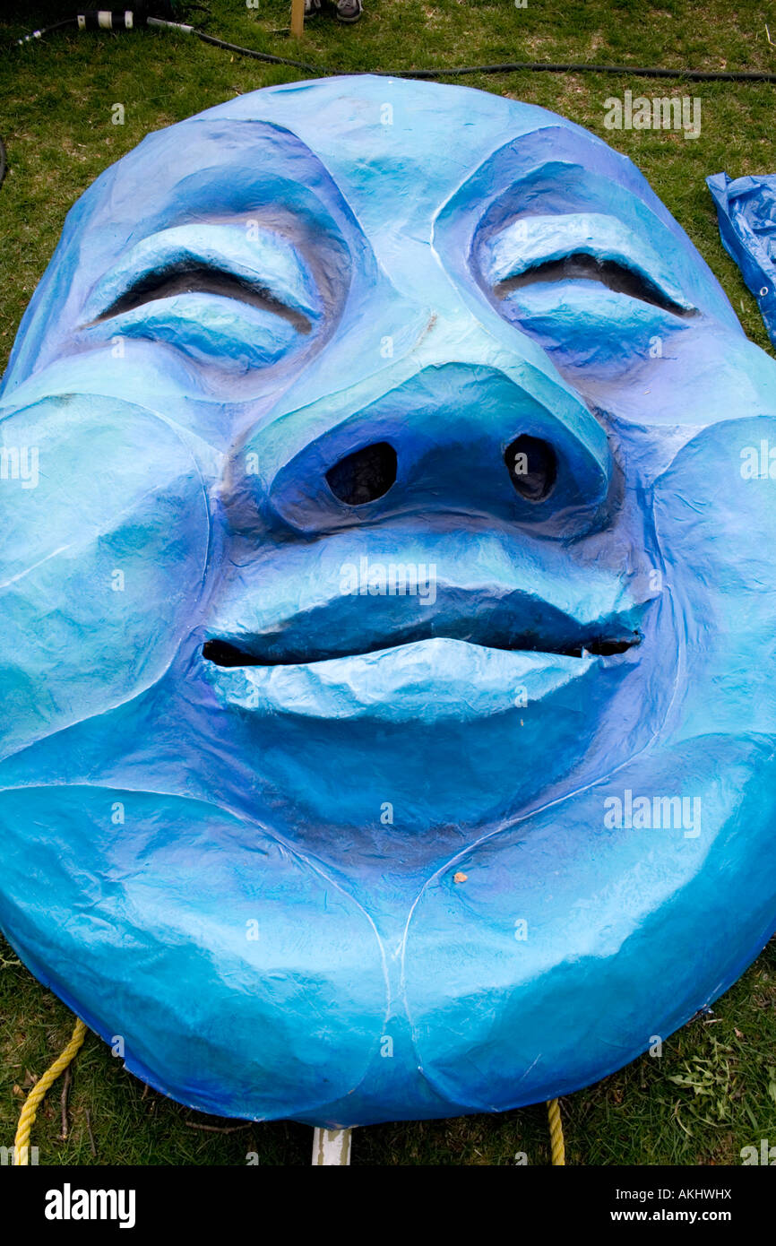 Blue paper mache face puppet from Tree of Life Ceremony. MayDay Parade and Festival Powderhorn Park. Minneapolis Minnesota USA Stock Photo