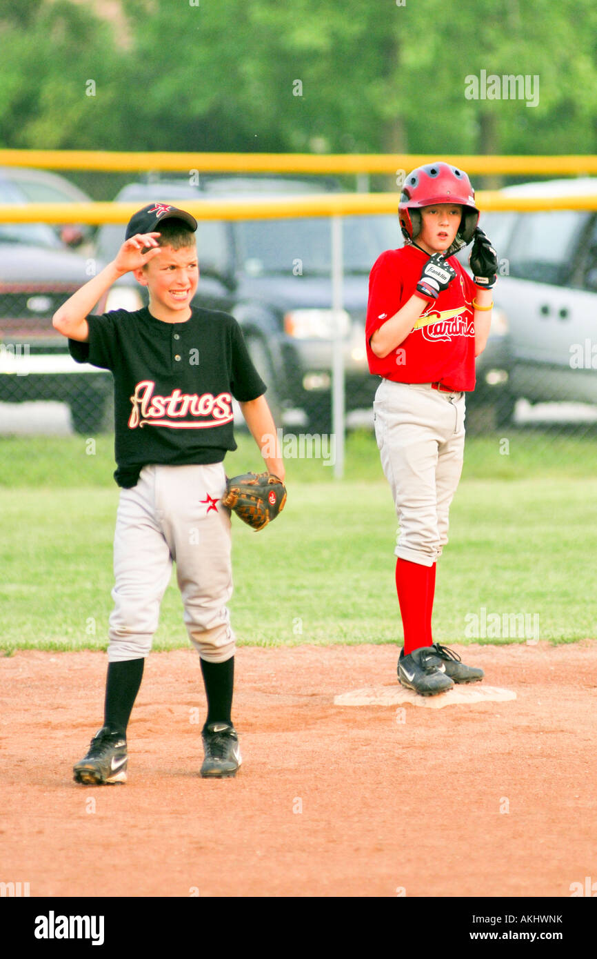 Young boys playing softball for the school team Stock Photo - Alamy