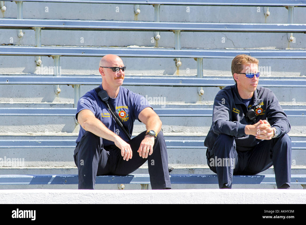 Paramedics wearing sunglasses sitting on a stadium bench at the Senior olypmics Marysville Michigan MI Stock Photo
