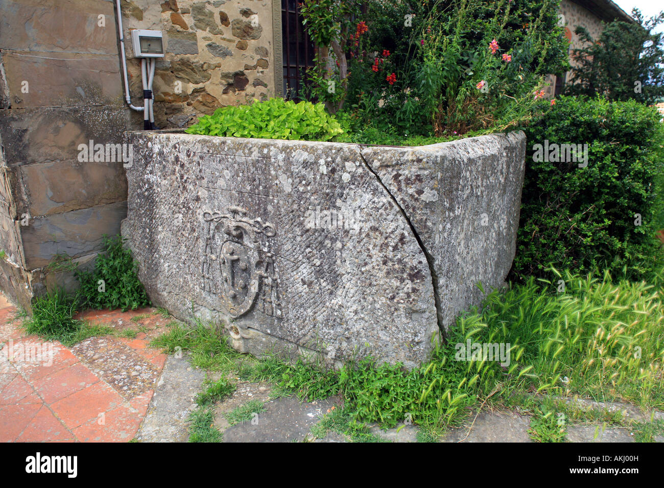 Stone tank to keep oil with Medici coat of arms, San Pietro a Pitana parish church, Reggello, Tuscany, Italy Stock Photo