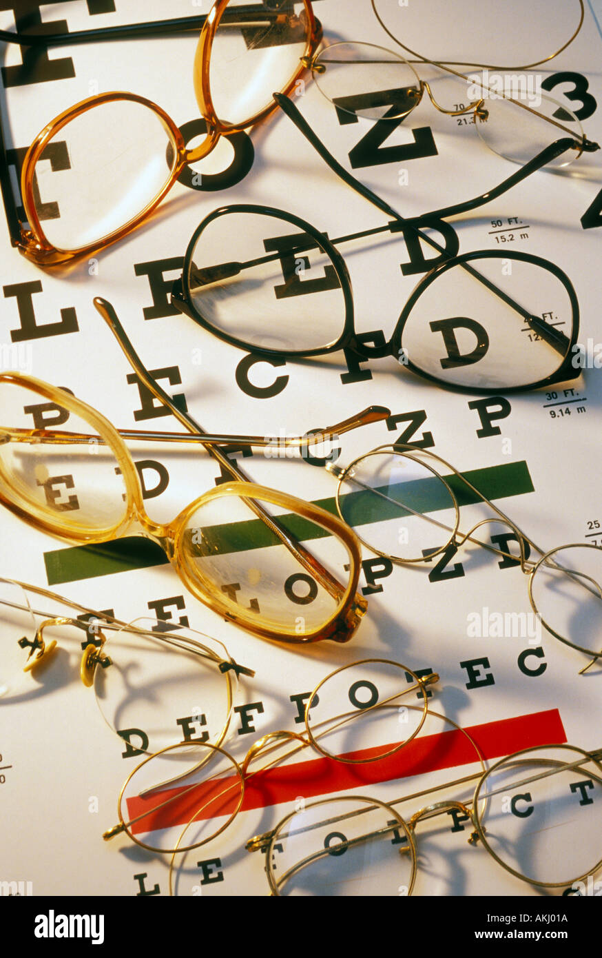 assorted eye glasses on eye chart Stock Photo