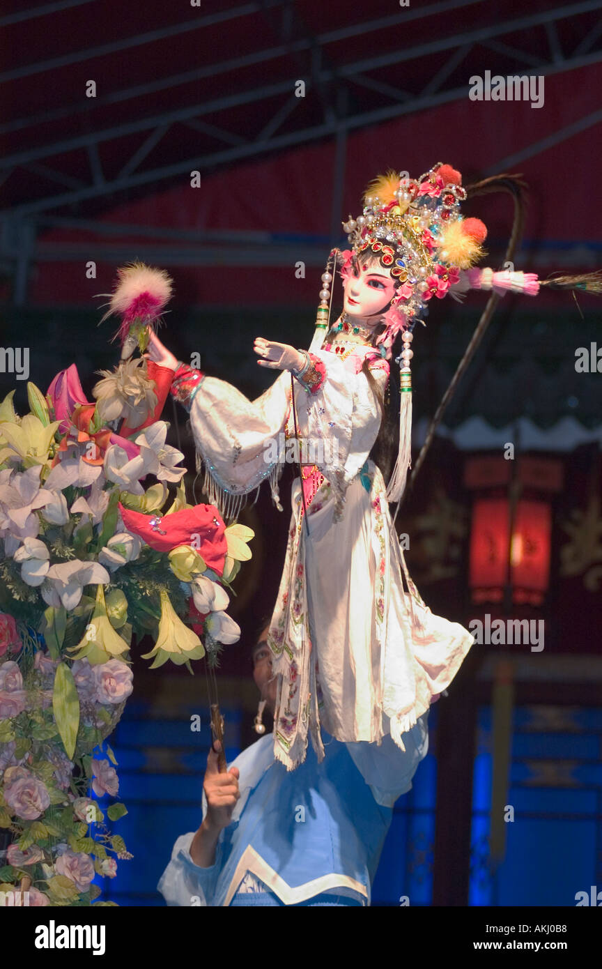 Female puppet picks a flower in a traditional Chinese Puppet Show drama ...