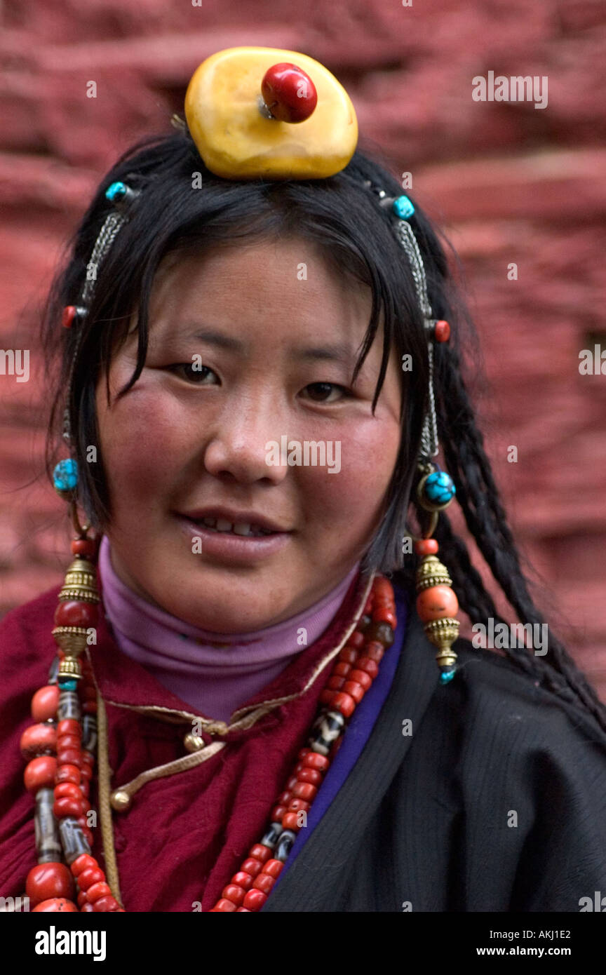 Khampa woman wears a amber red coral hair piece at the Monlam Chenpo Katok Monastery Kham Tibet Sichuan China Stock Photo