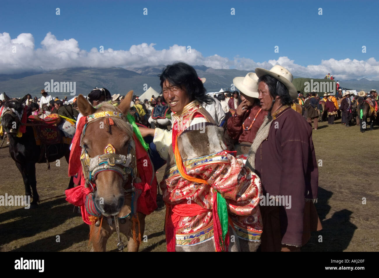 Khampa man Tibetan pony wait for a chance to race at the Litang Horse Festival Kham Sichuan Province China Tibet  Stock Photo