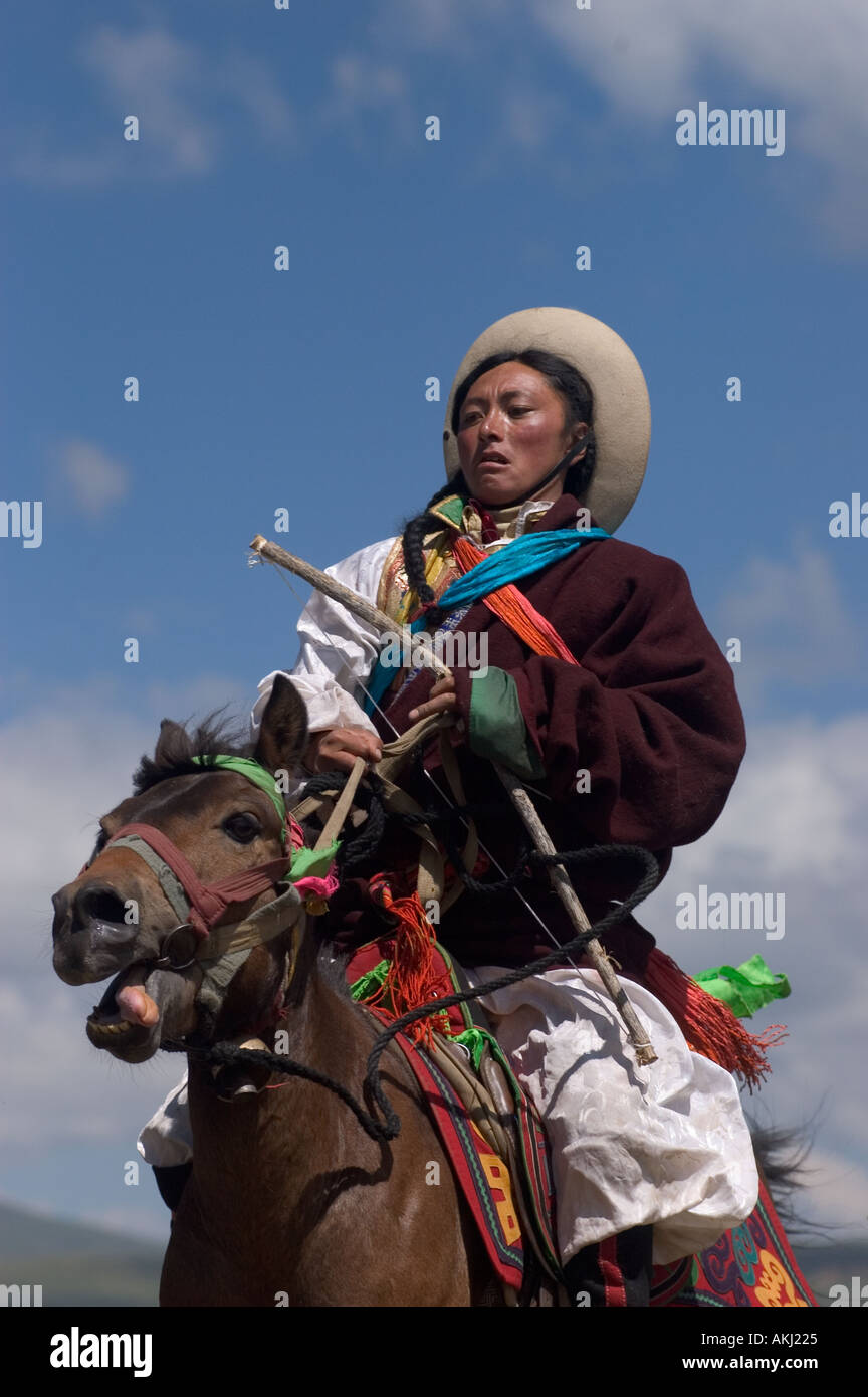 Khampas the warrior horseman of old Tibet compete at the Litang Horse Festival Kham Sichuan Province China Tibet  Stock Photo