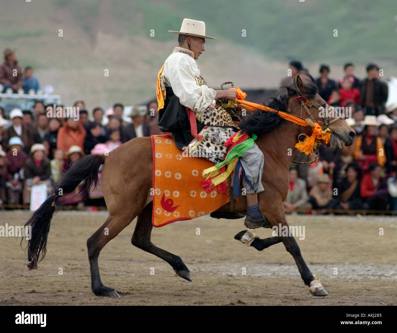 A Khampa participates in the dressage competition at the Litang Horse Festival in Kham Sichuan Province China Tibet  Stock Photo