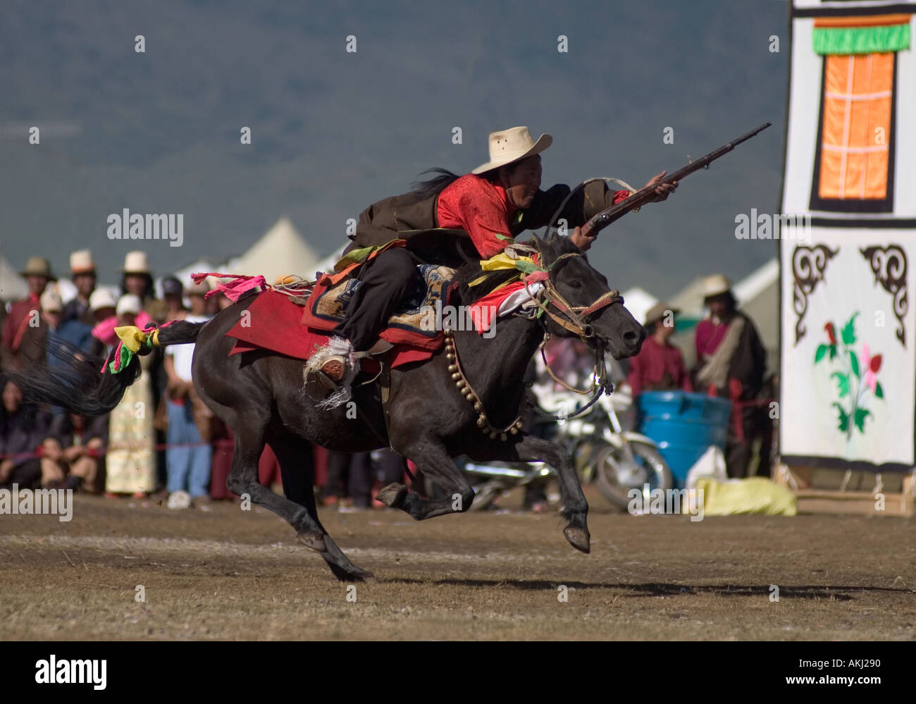 Khampas compete in rifle shooting contest on horseback at the Litang Horse Festival Kham Sichuan Province China Tibet  Stock Photo