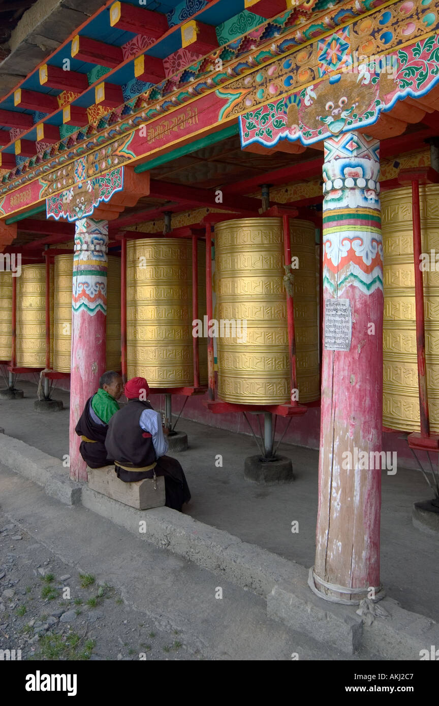 Pilgrims giant prayer wheels at the Buddhist Monastery of Tagong Lhagang Kham Sichuan Province China Tibet  Stock Photo