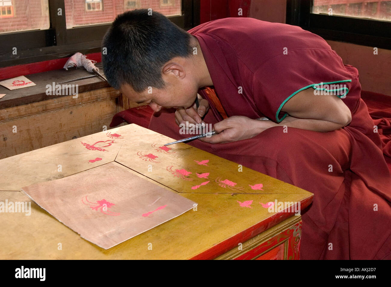Buddhist monk practices sand mandala painting in Dhokham Garther Monastery Kham Sichuan Province China Tibet  Stock Photo