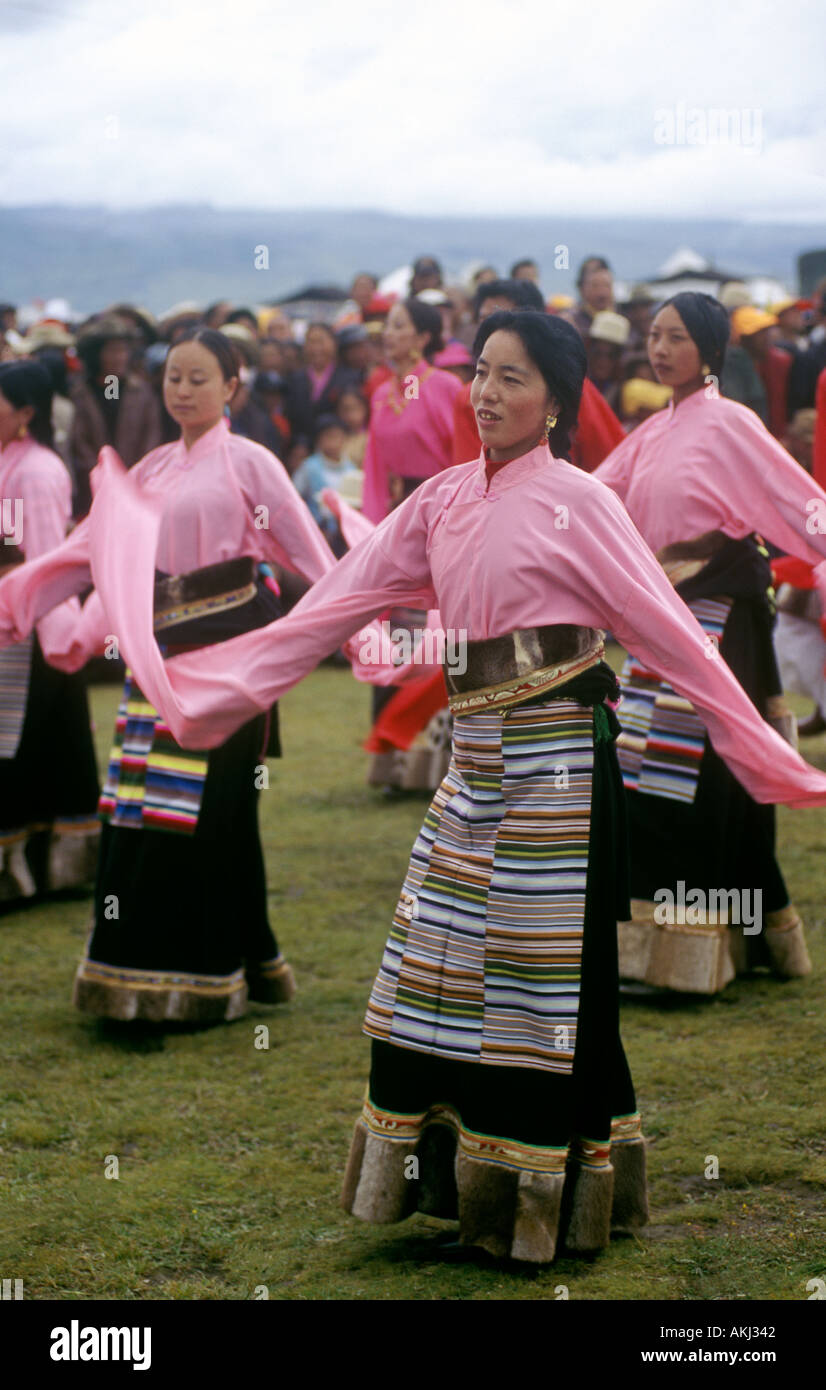 Female Dance troop with otter fur lined chubas preform at the Litang Horse Festival Kham Tibet Sichuan Province China Stock Photo