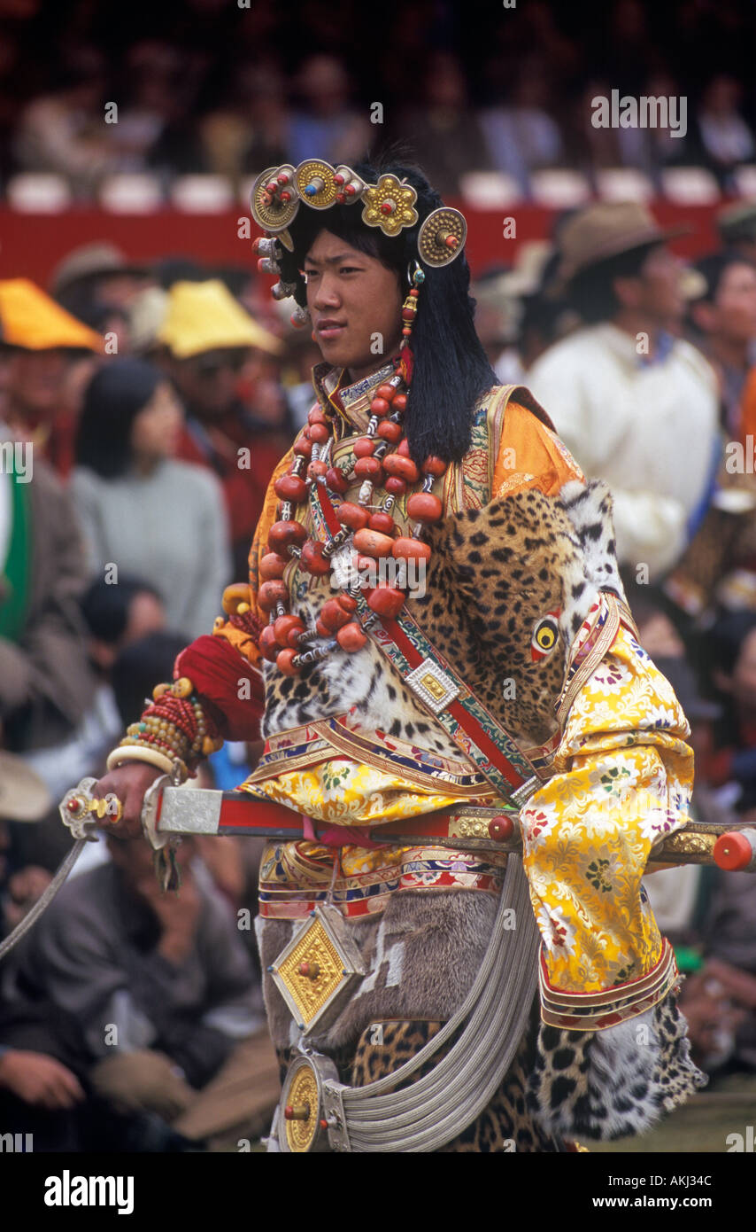 Male Khampa wears tiger skin coral zee stones gold gau boxes at the Litang  Stock Photo