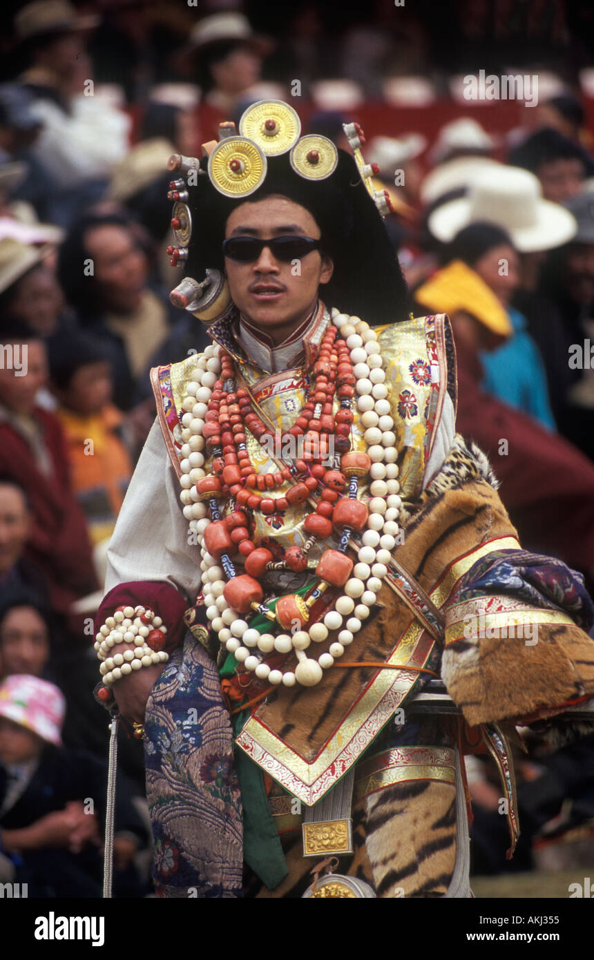 Male Khampa wears tiger skin coral zee stones gold gau boxes at the Litang Horse Festival Sichuan Province China Tibet  Stock Photo