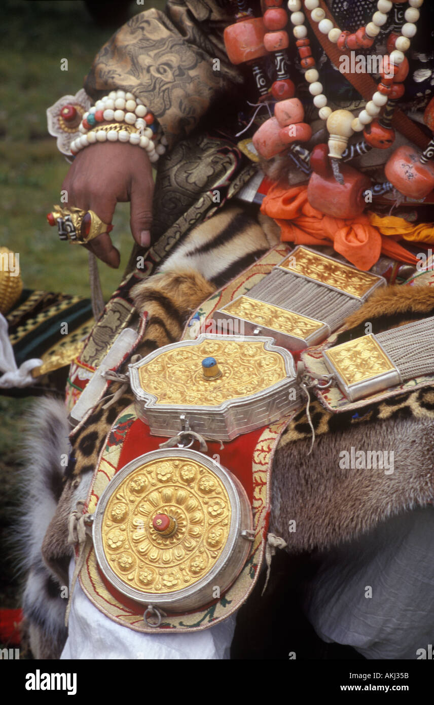 Male Khampa wears leopard skin coral zee stones gold gau boxes at the Litang Horse Festival Sichuan Province China Tibet  Stock Photo