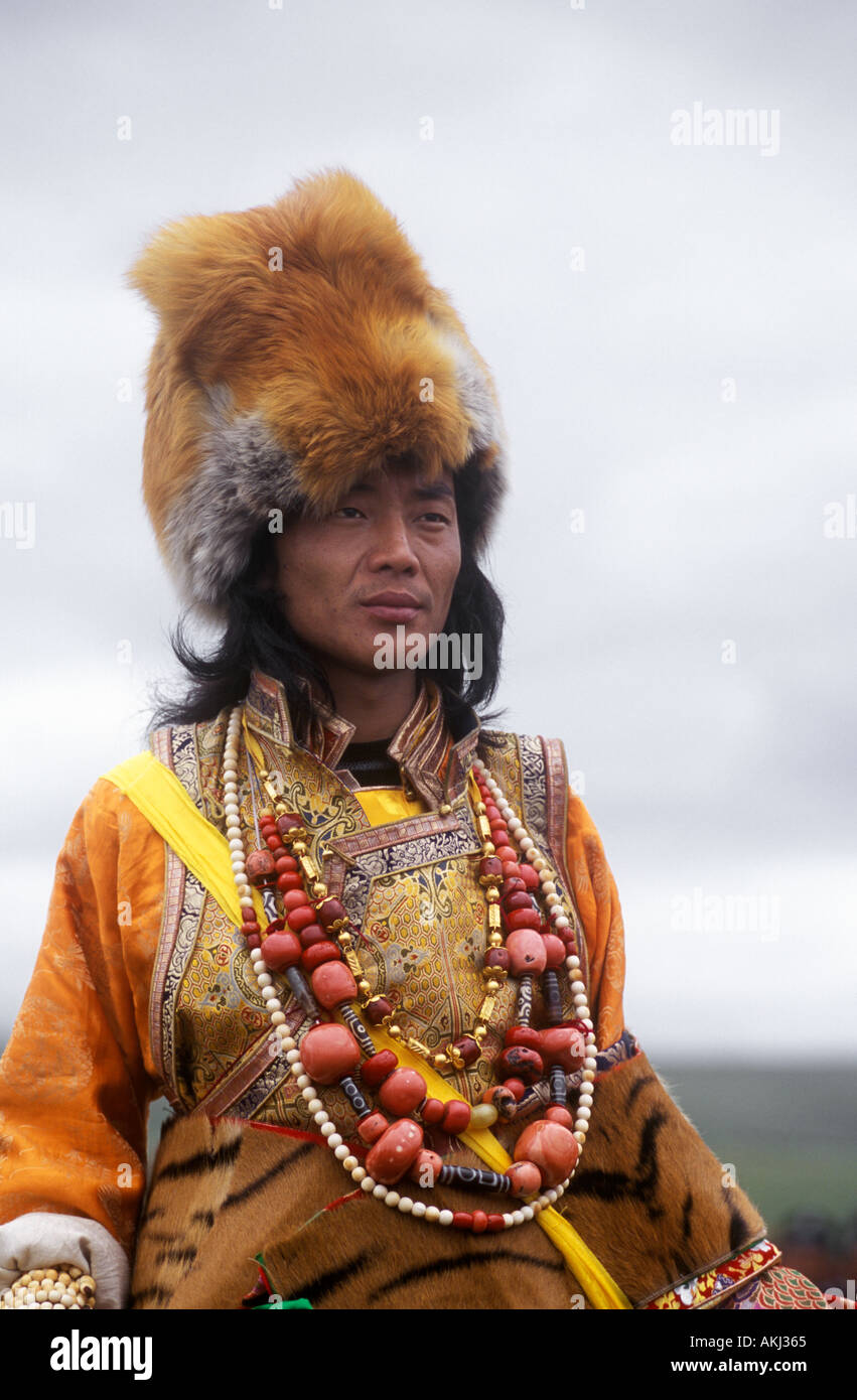 Male Khampa wears coral zee stones fox fur hat tiger skin at the Litang Horse Festival Sichuan Province China Tibet  Stock Photo