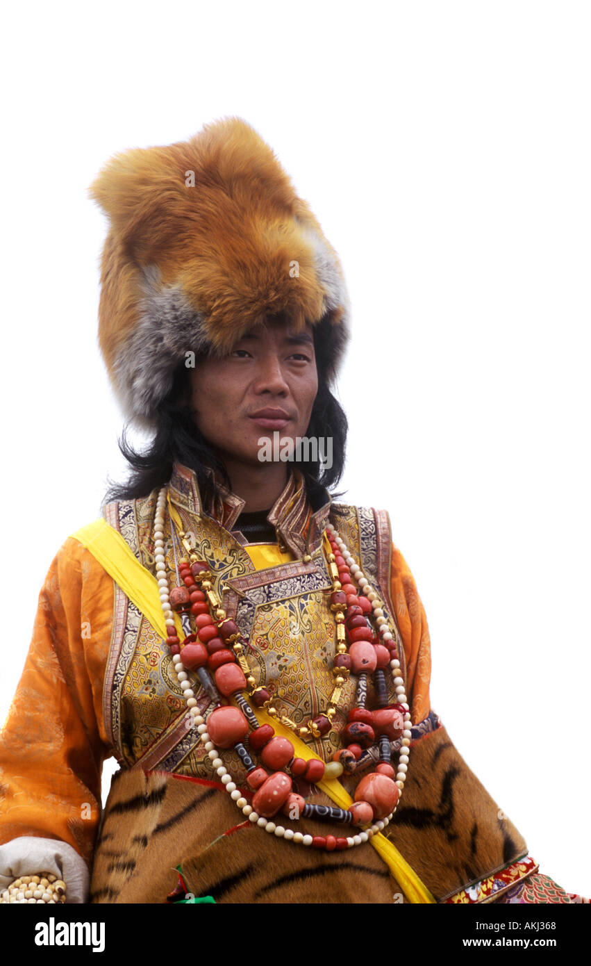 Male Khampa wears coral zee stones fox fur hat tiger skin at the Litang Horse Festival Sichuan Province China Tibet  Stock Photo